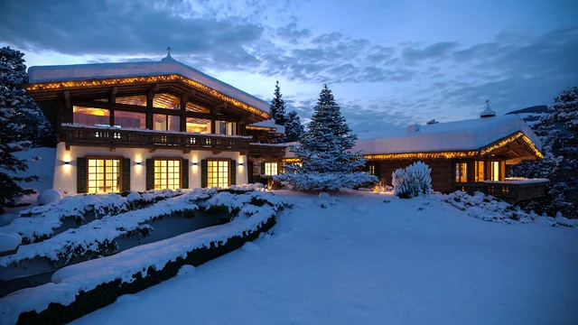 3d visualisierung eines luxuriösen Chalets in Kitzbühel, eingeschneit in eine Winterlandschaft mit warmem Licht und Weihnachtsdekoration, erstellt von gmsvision.