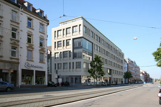 3D Visualization of a modern office building with a light facade, large windows, and integrated glass front located on a busy city street.