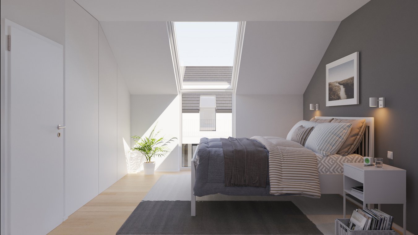 Cozy bedroom with gray accent wall and sloping ceiling.
