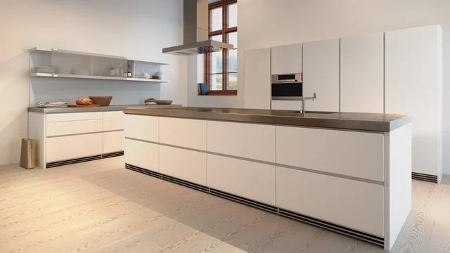 3D Visualization of a modern Bulthaup kitchen featuring a sleek island, minimalist white cabinetry, and natural wooden flooring.